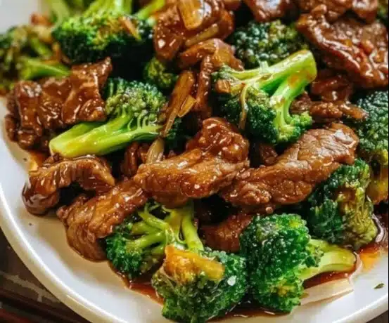 Delicious Chinese beef and broccoli stir-fry on a plate with rice.