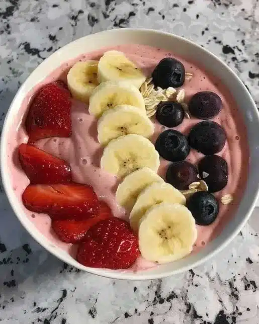 A vibrant 5-minute fruit smoothie bowl topped with fresh fruits and nuts.