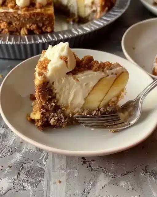 Slice of delicious apple crumble cheesecake with a crispy topping