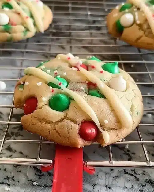 A variety of colorful Christmas cookies arranged on a festive table.