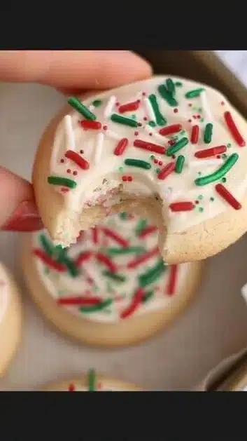 Decorated Christmas sugar cookies shaped like stars and trees on a festive table.