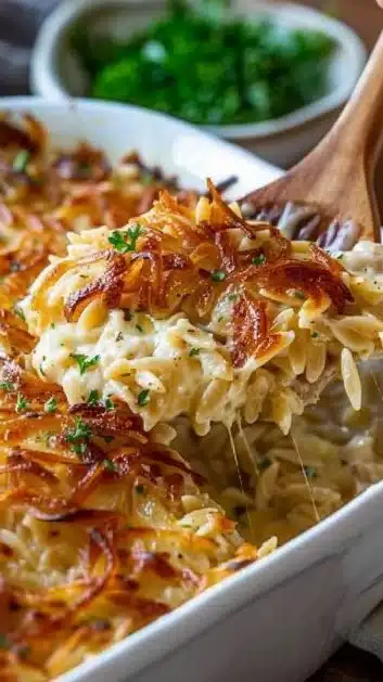 Delicious French Onion Chicken Orzo Casserole topped with melted cheese
