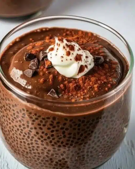 A creamy bowl of high protein chocolate chia seed pudding, topped with fruits.