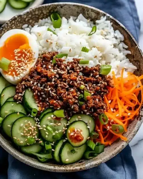 Delicious Korean Ground Beef Bowl topped with colorful vegetables