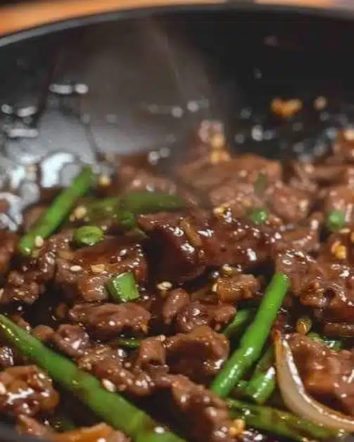 Plate of Mongolian Beef with scallions in a flavorful sauce