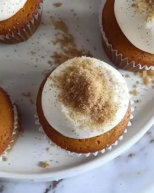 Delicious Pumpkin Cheesecake Cupcakes topped with creamy frosting