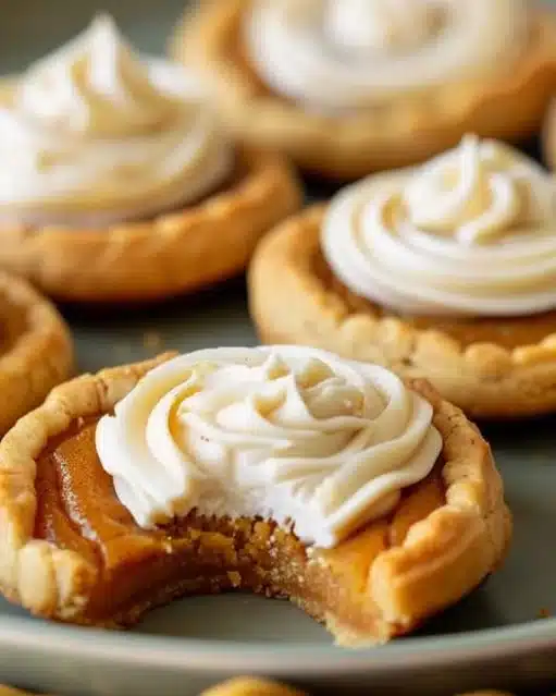 Delicious homemade pumpkin pie cookies decorated with fall spices and icing