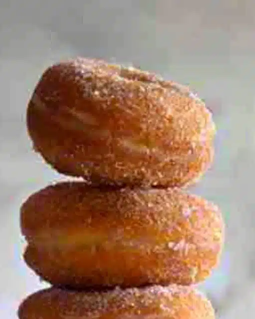 Freshly baked Pumpkin Spice Donuts with frosting and cinnamon sprinkles