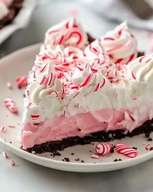 Quick Christmas Peppermint Pie topped with whipped cream and crushed candy canes