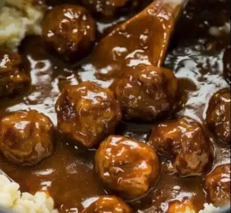 Delicious slow cooker Salisbury steak meatballs served with gravy and mashed potatoes.