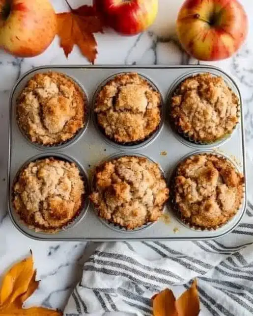 Freshly baked apple cinnamon cottage cheese muffins on a wooden table