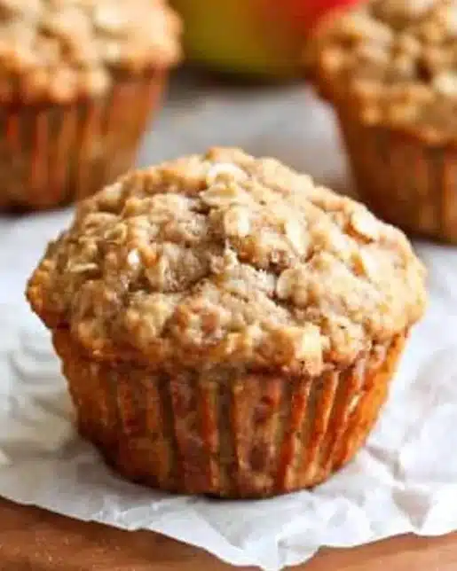 Healthy Apple Cinnamon Oat Muffins in a rustic setting