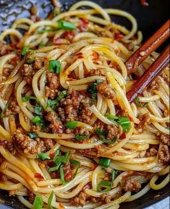 Asian-style Ground Beef Spaghetti served in a bowl with fresh vegetables