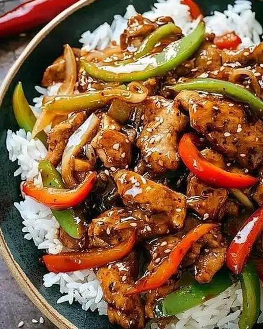 Delicious black pepper chicken served on a plate with vegetables