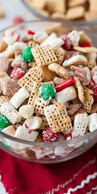 Festive bowl of homemade Christmas Chex Mix with holiday decorations