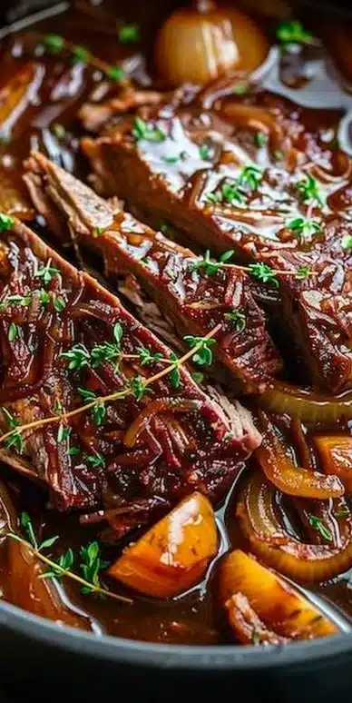Delicious French onion pot roast garnished with herbs and served with vegetables