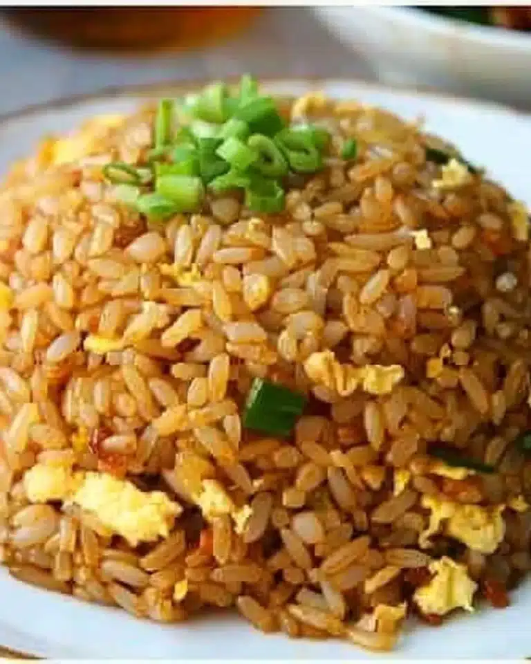Plate of easy 10-minute fried rice garnished with vegetables and egg