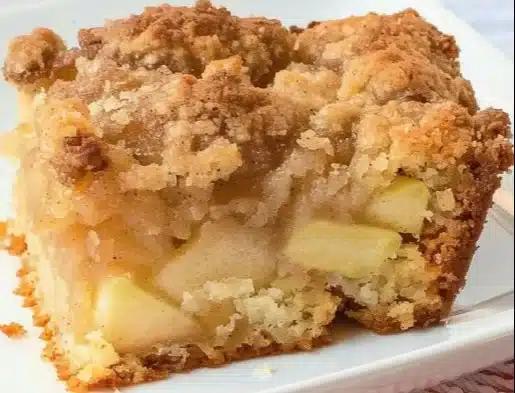 Slice of Easy Apple Crumb Cake topped with crumbly streusel and fresh apples
