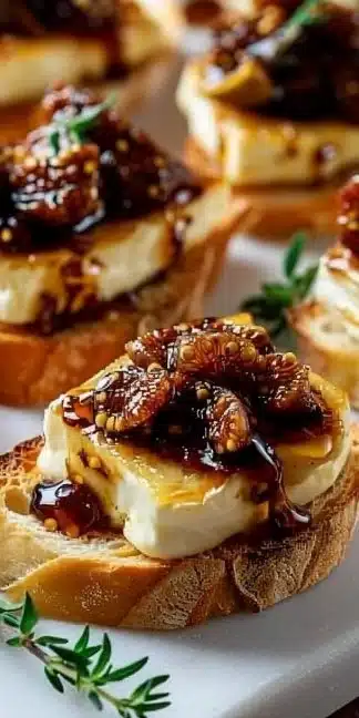 Fig & Brie Crostini topped with figs and cheese on a toasted baguette