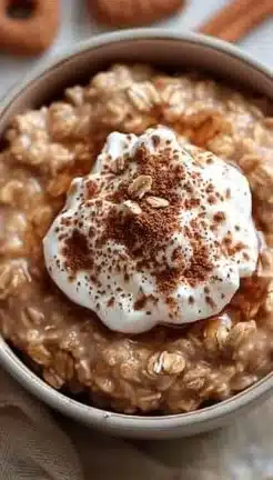 Bowl of Gingerbread Oatmeal topped with cinnamon and nuts
