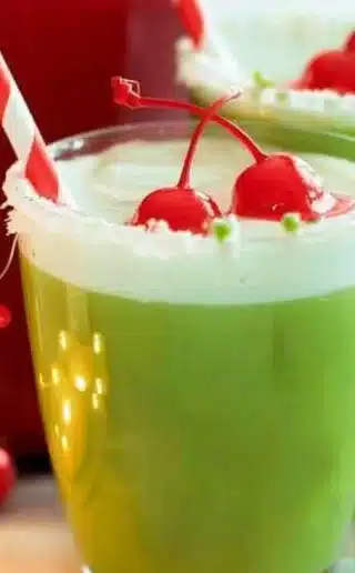Festive Grinch Punch served in a holiday-themed glass.