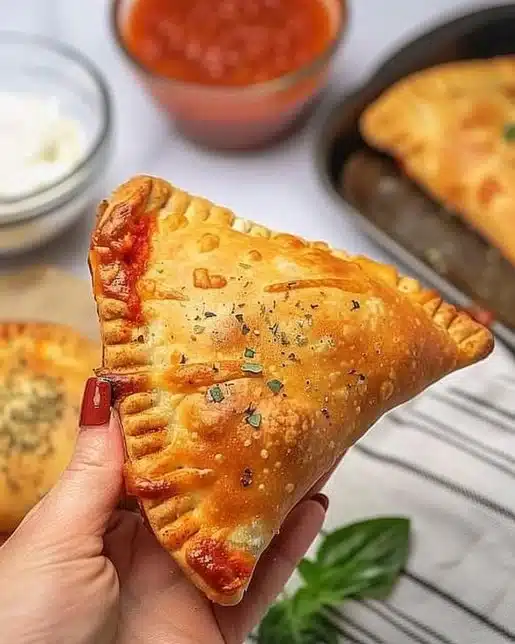 Homemade pizza pockets filled with cheese and pepperoni on a plate
