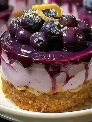 Mini lemon blueberry cheesecake topped with fresh blueberries and lemon zest.