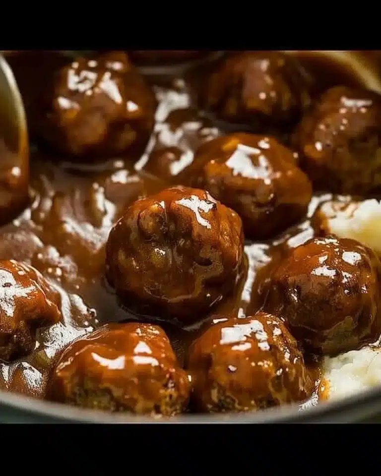 Delicious slow cooker Salisbury steak meatballs served with gravy and mashed potatoes.