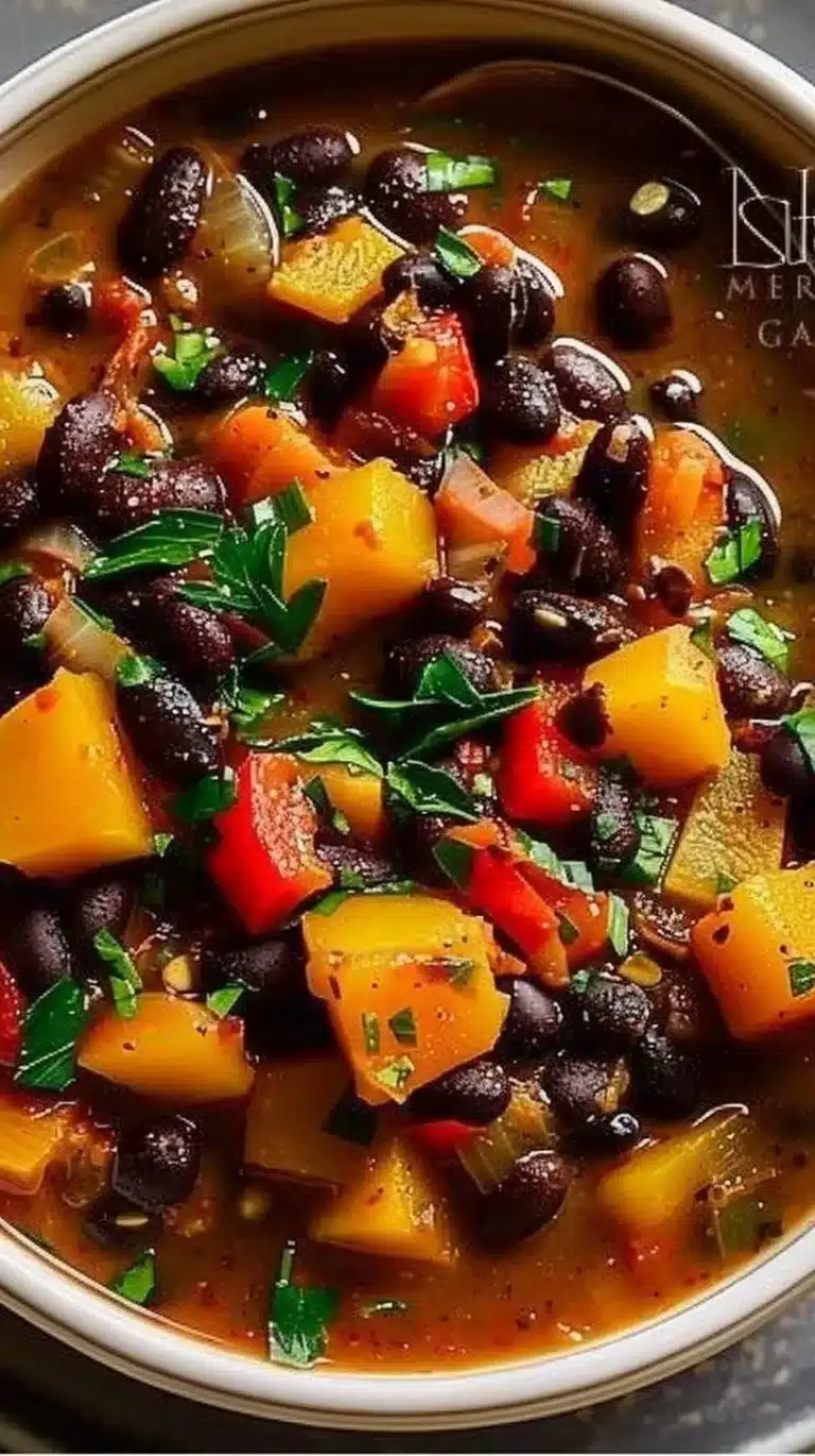 Bowl of hearty black bean squash stew with fresh ingredients