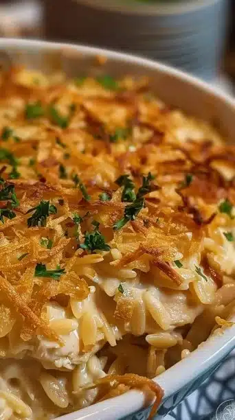 Delicious French onion chicken orzo casserole garnished with herbs